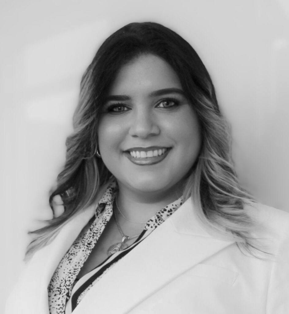 Smiling woman in a professional outfit.
