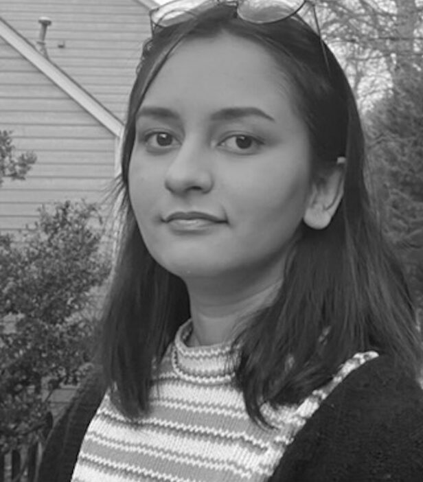 Young woman with long hair looking confidently.
