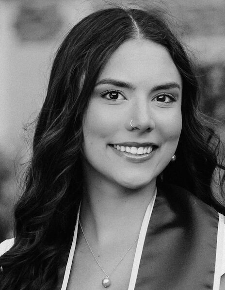 Smiling woman with long, wavy hair.