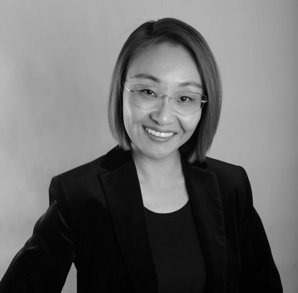 Smiling woman in a black blazer.